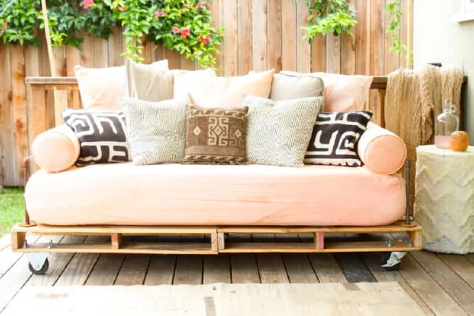 A daybed made from inexpensive pallets, and pipe that you can find at any home center.